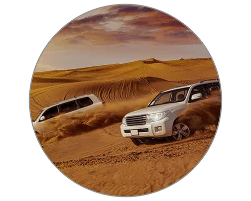 Two 4x4 vehicles racing across the sandy terrain on a thrilling Dubai desert safari tour.